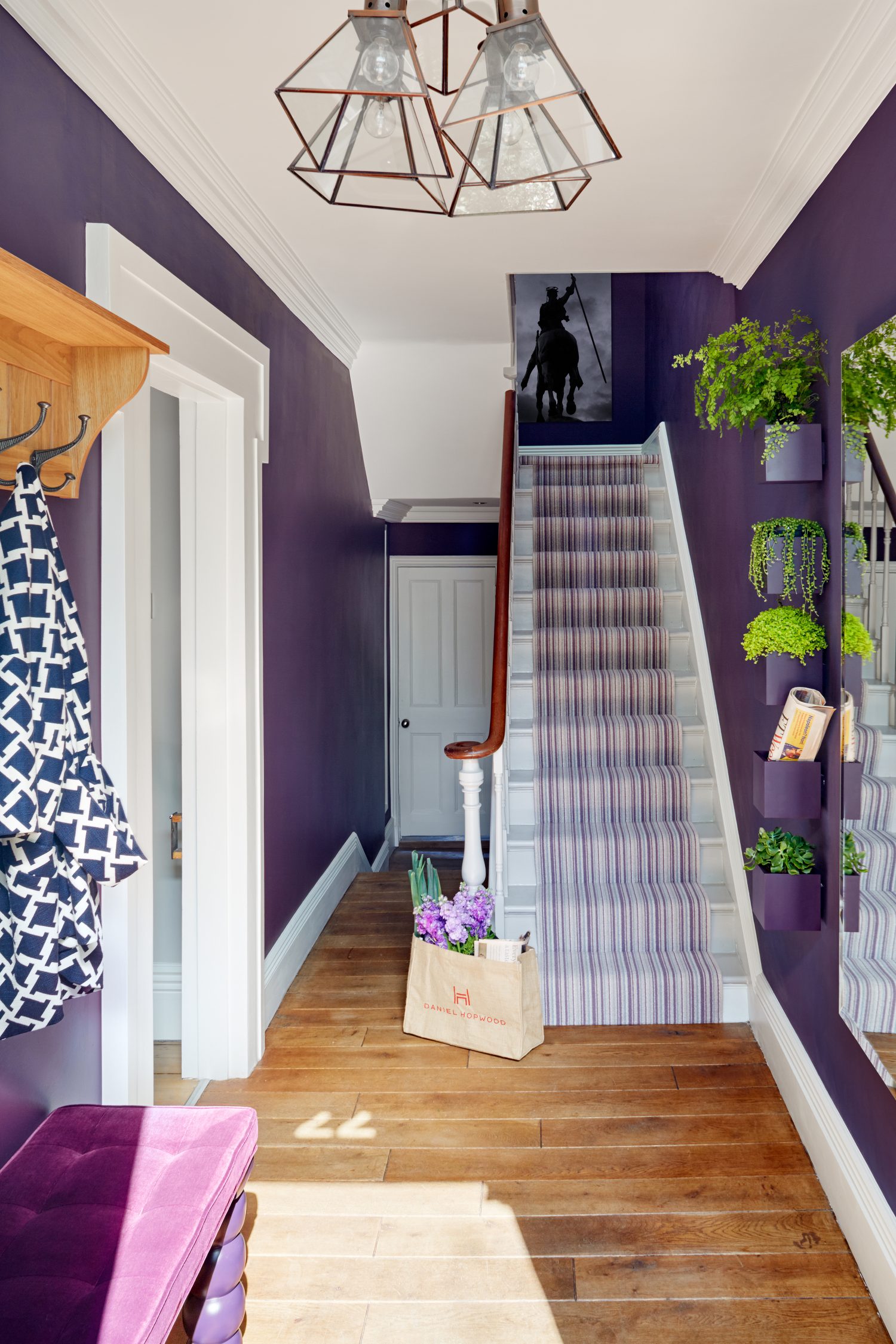 Happy House by Daniel Hopwood – deep purple hallway with high street lighting. Eclectic design