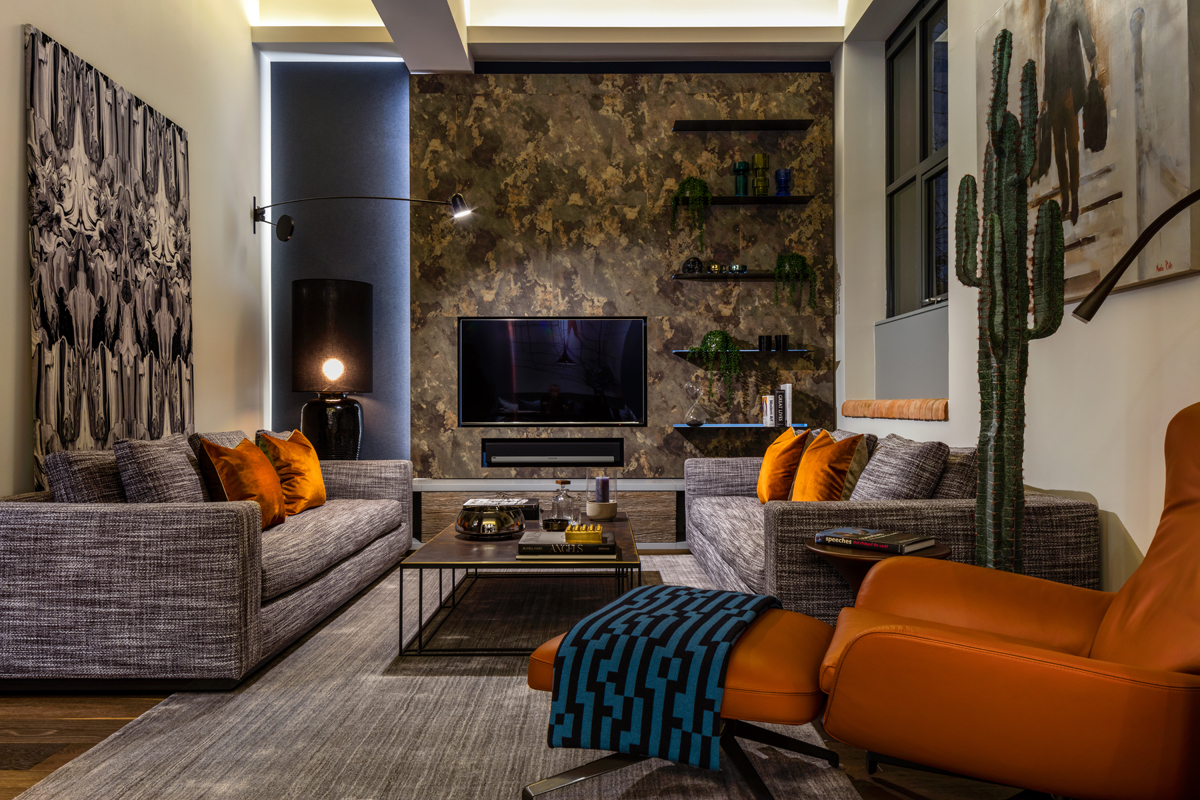 Gentleman’s Quarters by Daniel Hopwood – modern living room with orange accents. Masculine interior design